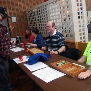 Two members of South Pickering Amateur Radio Club help with attendance to the event. Randy (VE3JPU) takes a short break to pose for the photo while Kent (VE3JPU) welcomes an attendee.