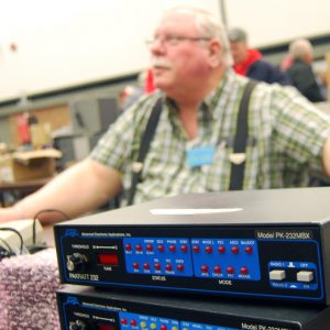 An artistic photograph of a converter. A member of South Pickering Amateur Radio club can be seen blurred in the background.
