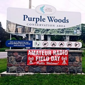 Photo of our banner on the Purple Woods entrance sign at our 2017 Field Day location.
