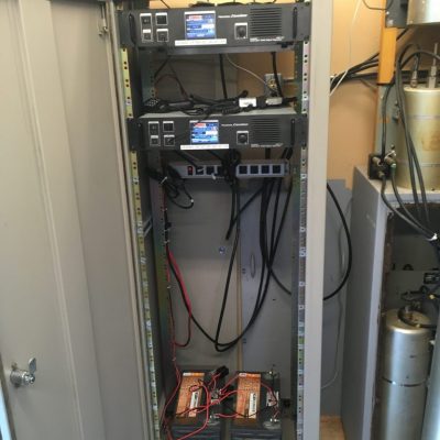 Inside the repeater cabinet. These are our two core repeaters VE3OSH and VE3NAA, including their power and battery backups.
